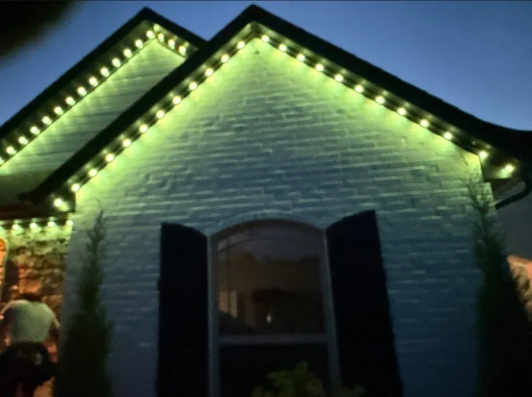Brick gable washed in green from roofline lights