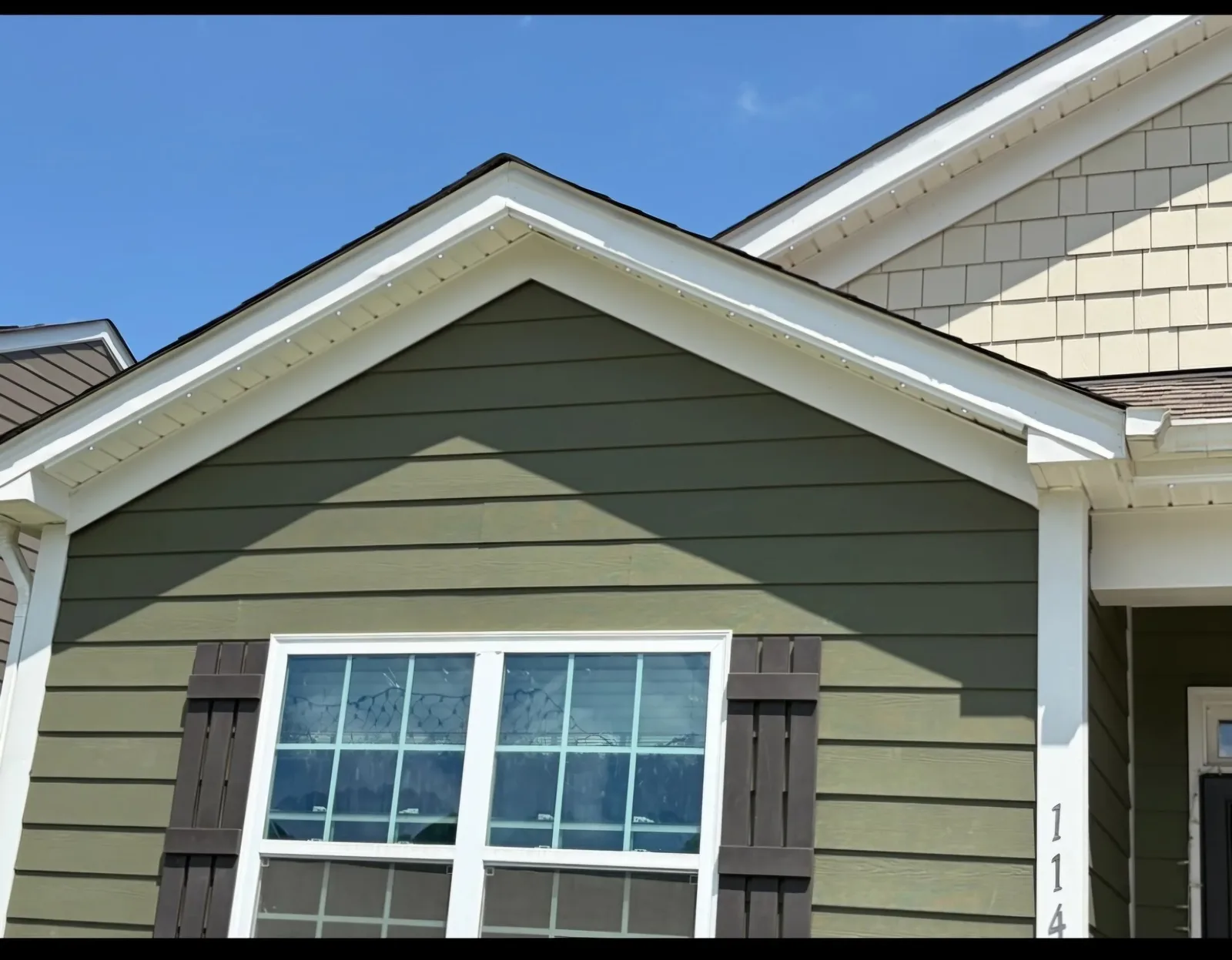 New gutters on a green-sided home