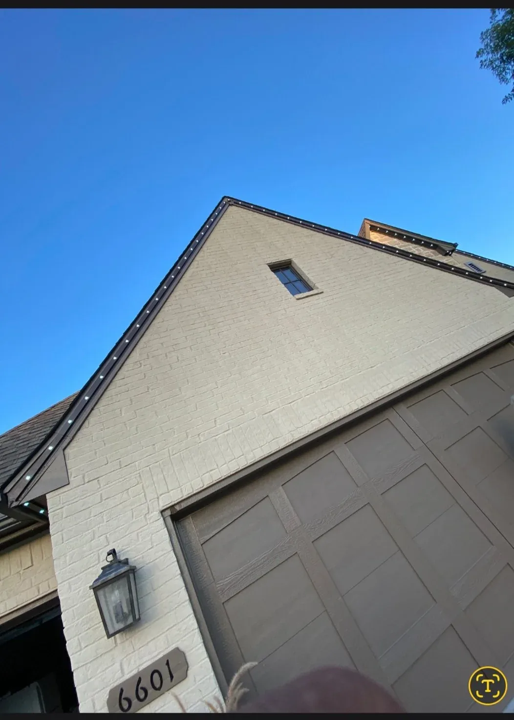 Seamless gutter along a tan brick gable