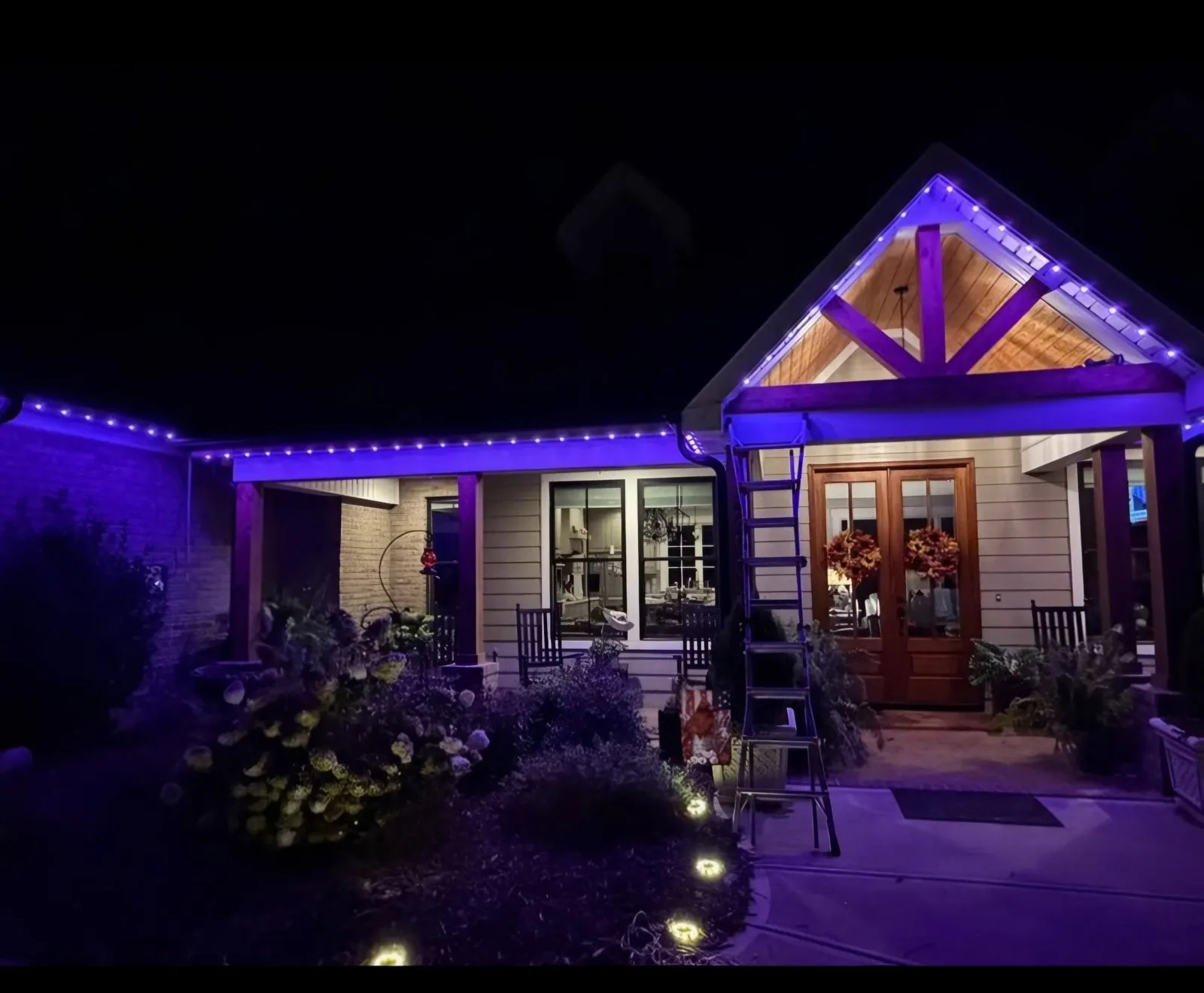 Timber-framed porch glowing purple at night