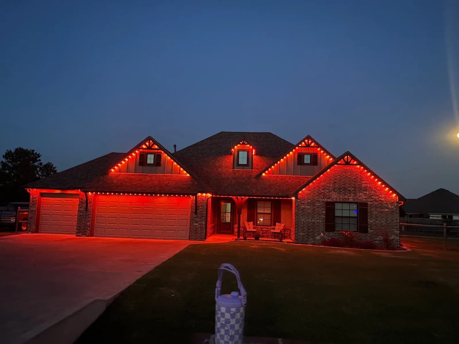 Brick ranch home glowing red at dusk