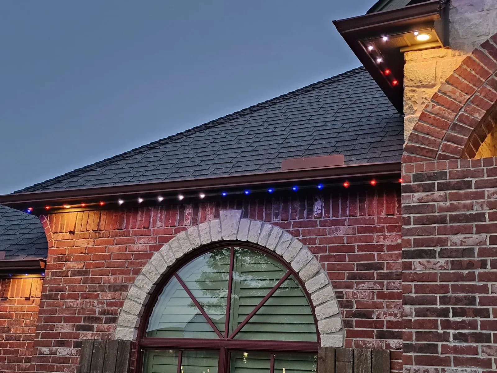 Brick arch and gable with red, white and blue lights