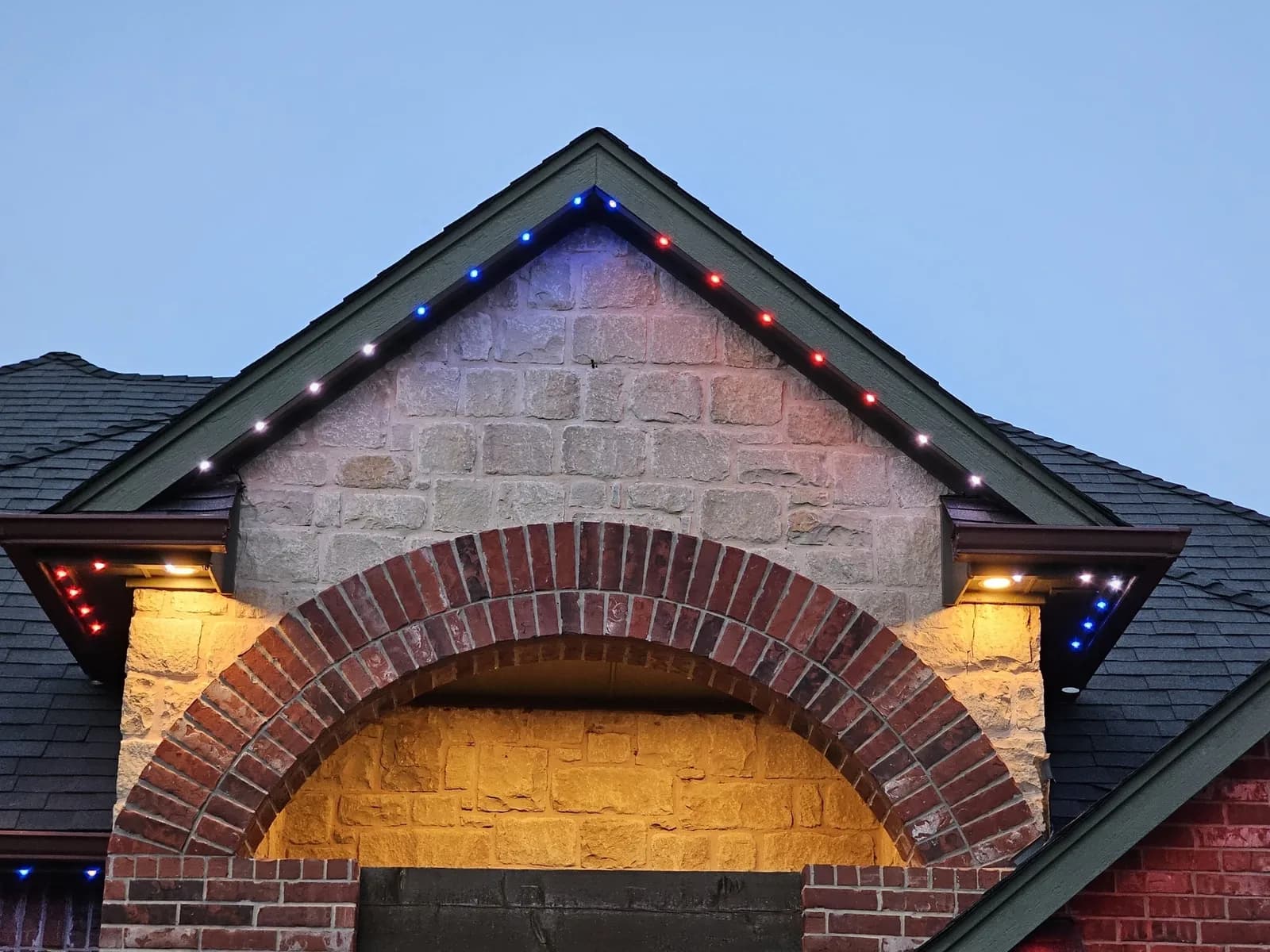 Stone arch entry lit red, white and blue for the Fourth of July