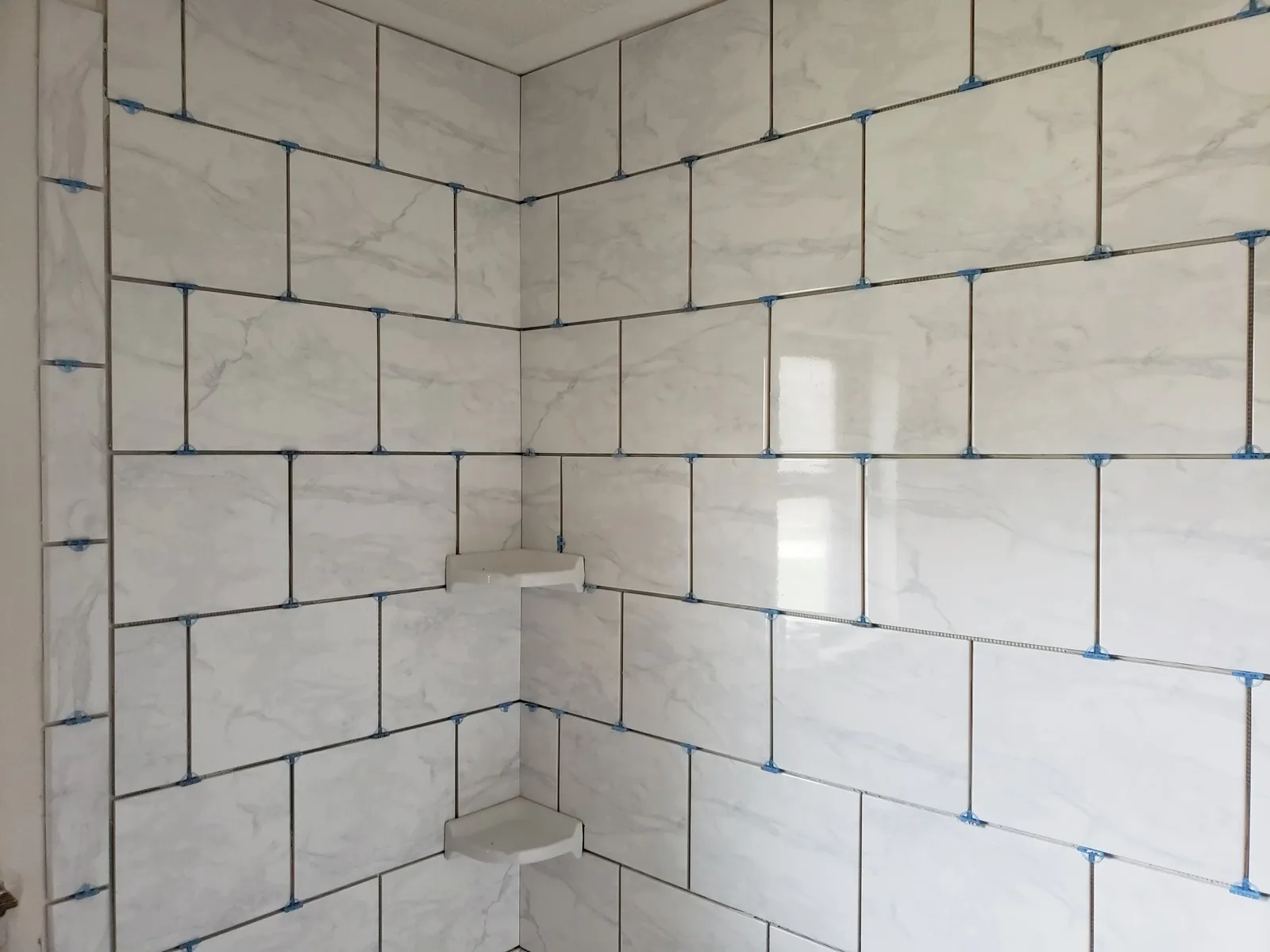 Wall tile being set with spacers